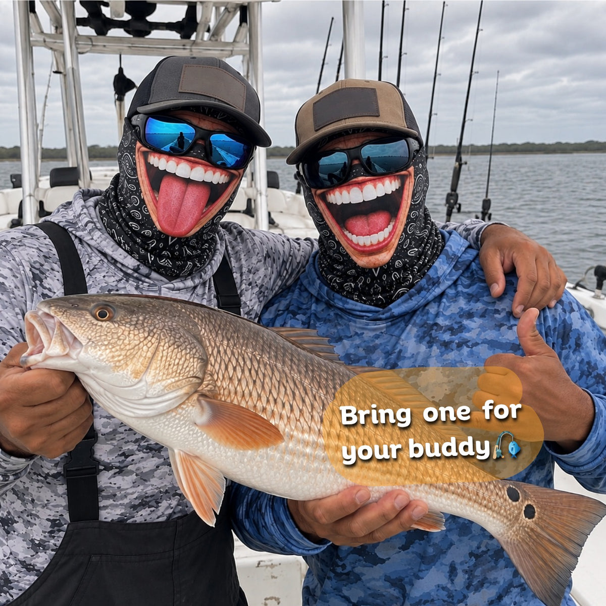Two anglers in Grinwear Tongue Out and Belly Laugh funny face balaclavas holding a redfish on a boat